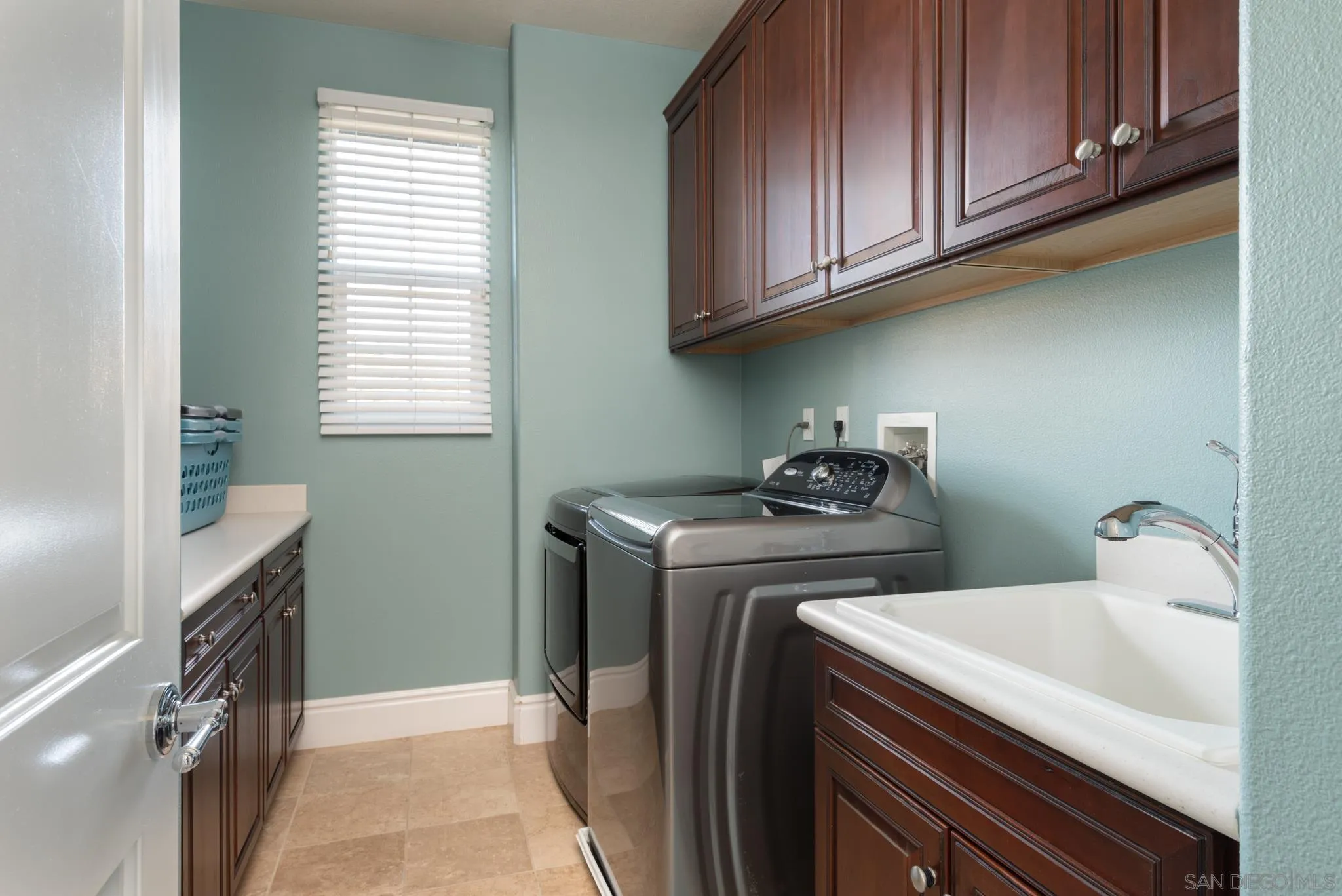 3234 Corte Aliso Carlsbad, CA 92009 - Photo 26 of 44 a utility room with sink dryer and washer