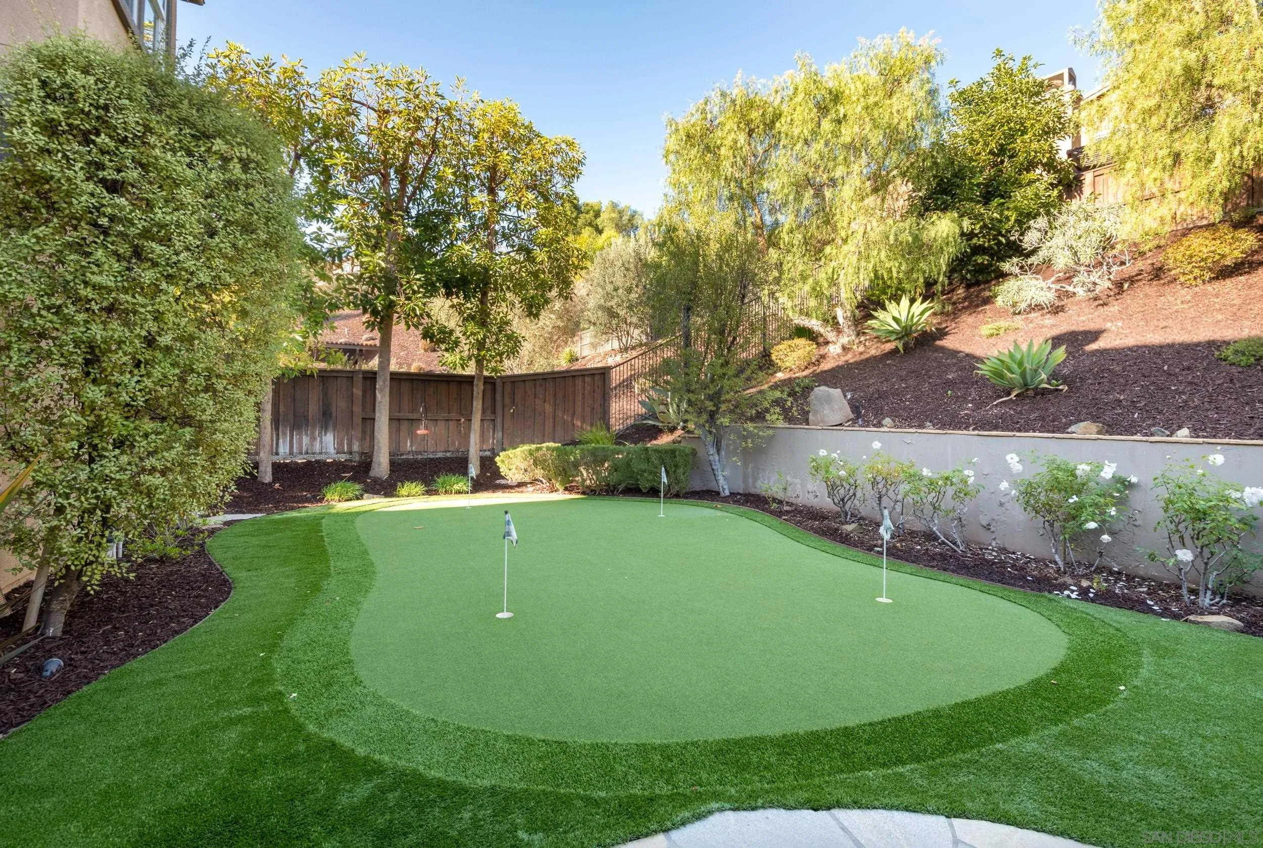 3234 Corte Aliso Carlsbad, CA 92009 - Photo 29 of 44 a view of an house with backyard space and garden
