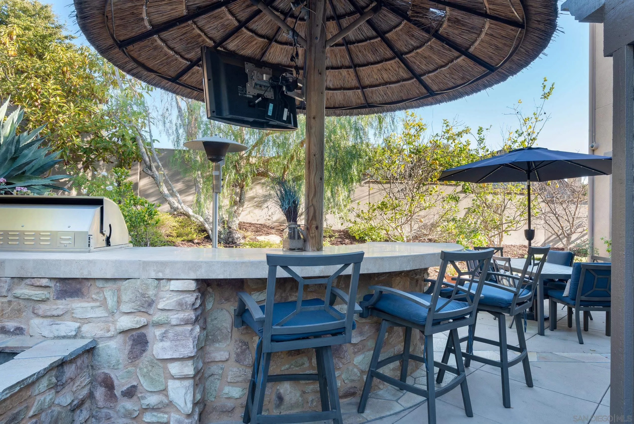 3234 Corte Aliso Carlsbad, CA 92009 - Photo 31 of 44 a view of patio with table and chairs under an umbrella with a sink