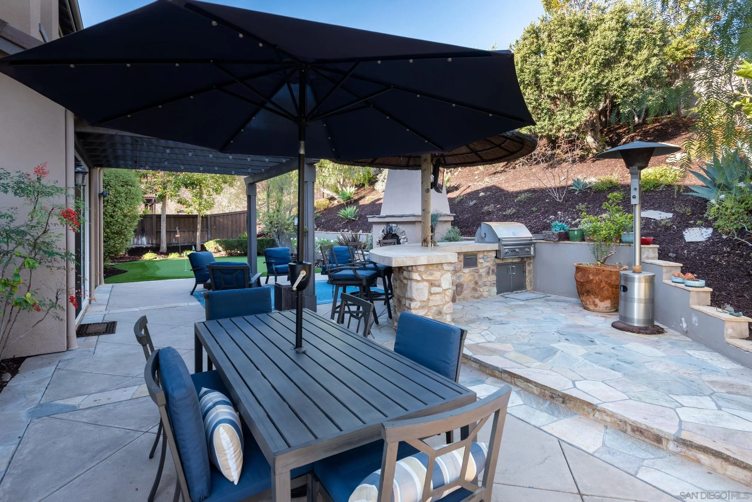 3234 Corte Aliso Carlsbad, CA 92009 - Photo 33 of 44 a view of a roof deck with table and chairs under an umbrella