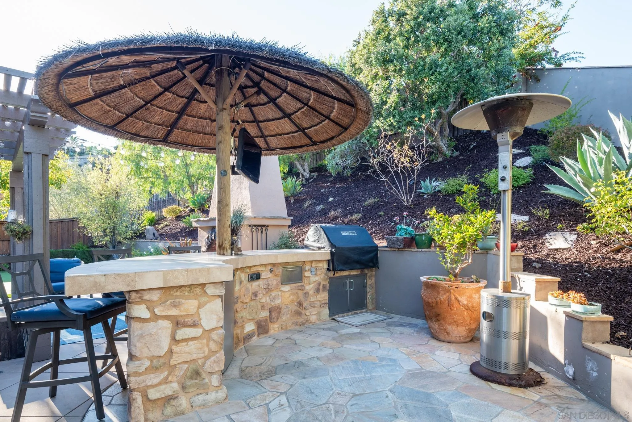 3234 Corte Aliso Carlsbad, CA 92009 - Photo 37 of 44 a view of a patio with table and chairs potted plants