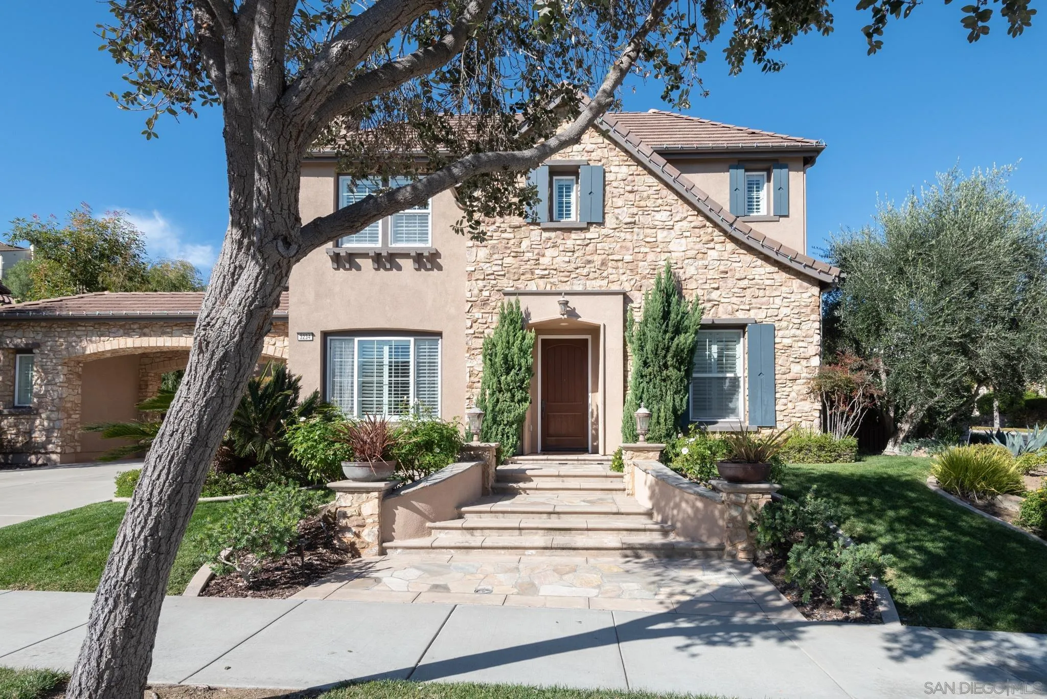 3234 Corte Aliso Carlsbad, CA 92009 - Photo 41 of 44 a front view of a house with a garden