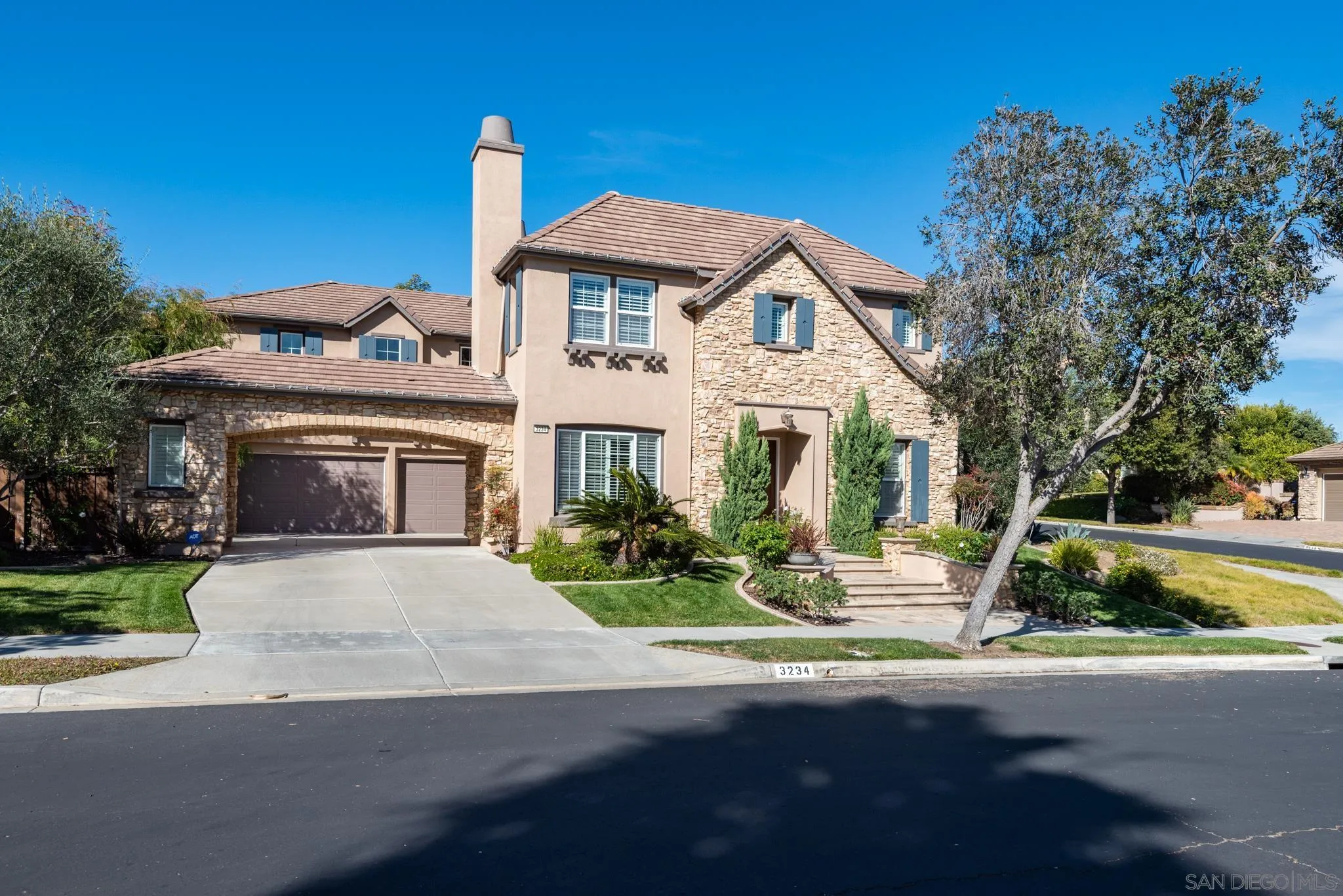 3234 Corte Aliso Carlsbad, CA 92009 - Photo 42 of 44 a front view of a house with garden