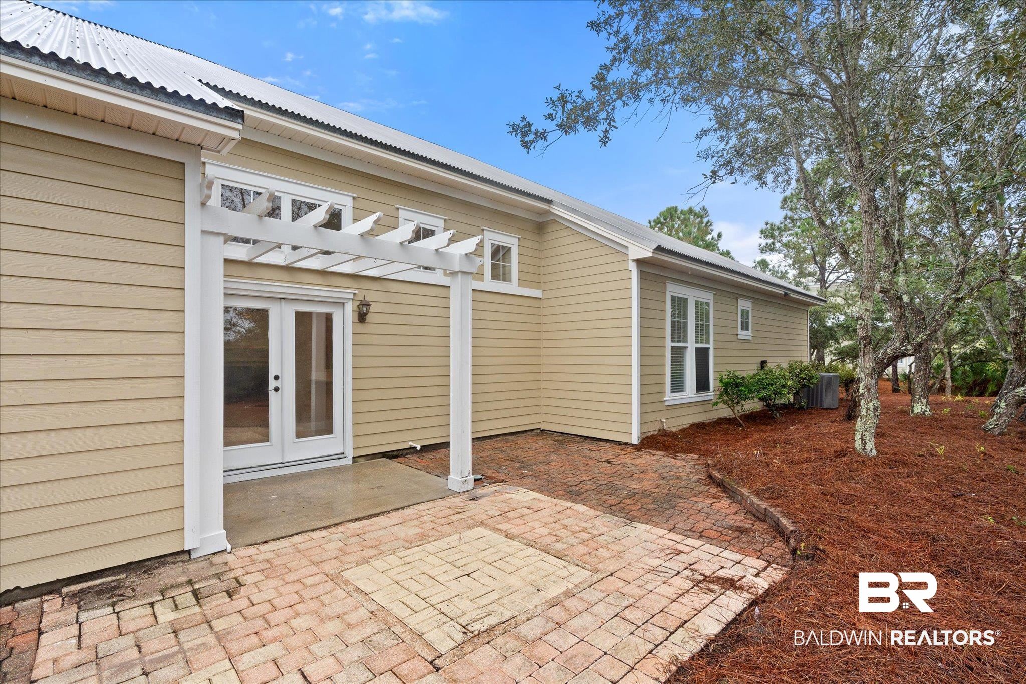 9259 Genipa Way Gulf Shores, AL 36542 - Photo 43 of 72 Rear view of property featuring central air condition unit and a patio area