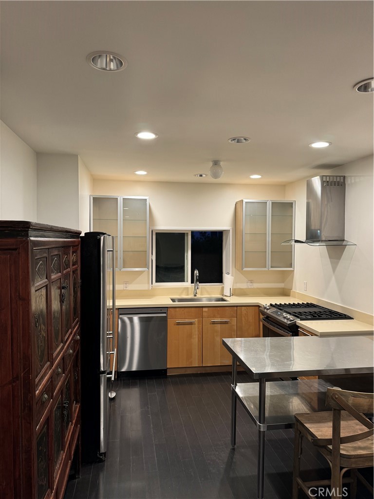 a kitchen with stainless steel appliances granite countertop a stove refrigerator sink and microwave