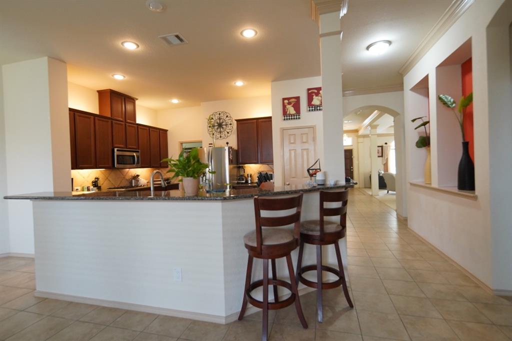 4508 Fox Rio Trail Arlington, TX 76017 - Photo 25 of 28 a living room with stainless steel appliances furniture a rug and a kitchen view