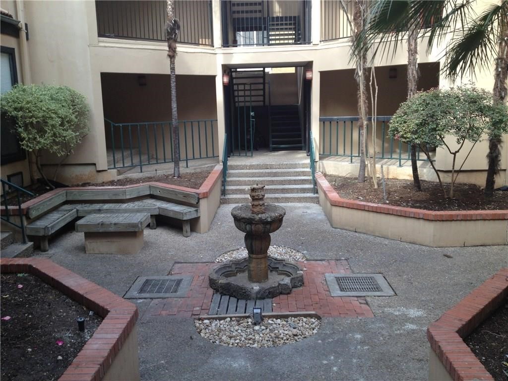 a view of a house with backyard fountain and a fountain