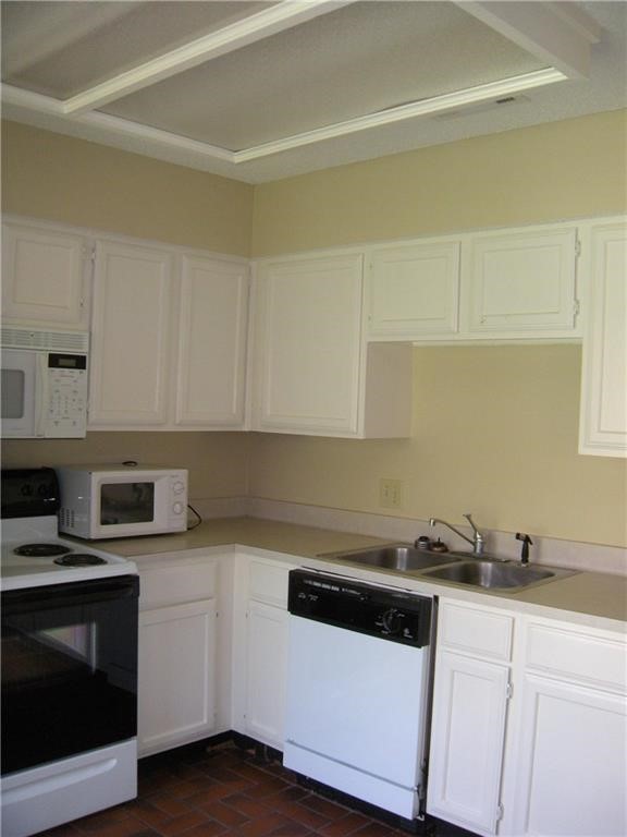 2110 Rio Grande Street, Unit 302 Austin, TX 78705 - Photo 9 of 22 a kitchen with granite countertop white cabinets and stainless steel appliances
