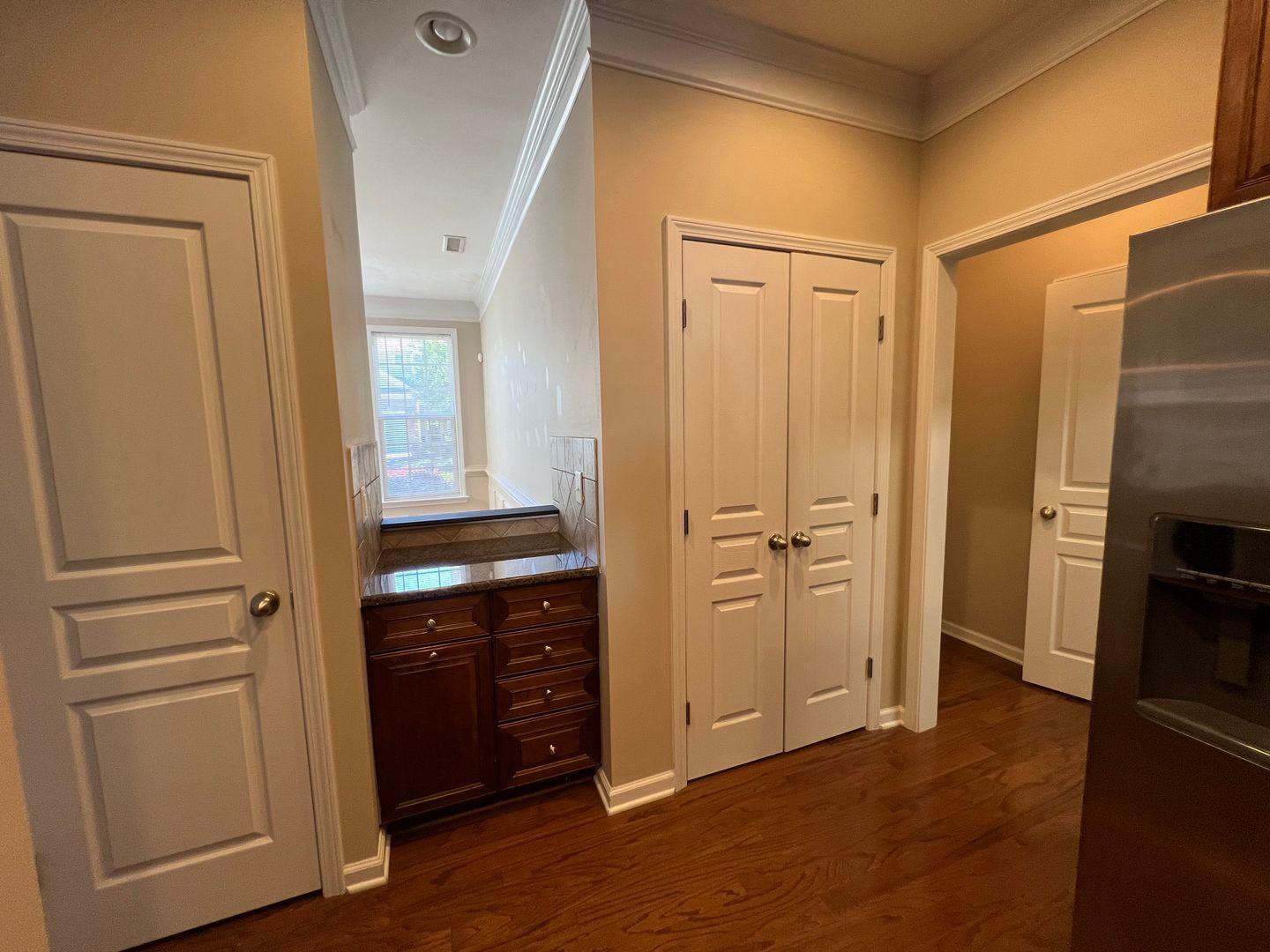 10117 Falls Meadow Court Raleigh, NC 27617 - Photo 12 of 34 a view of a kitchen with a refrigerator cabinets and a wooden floor