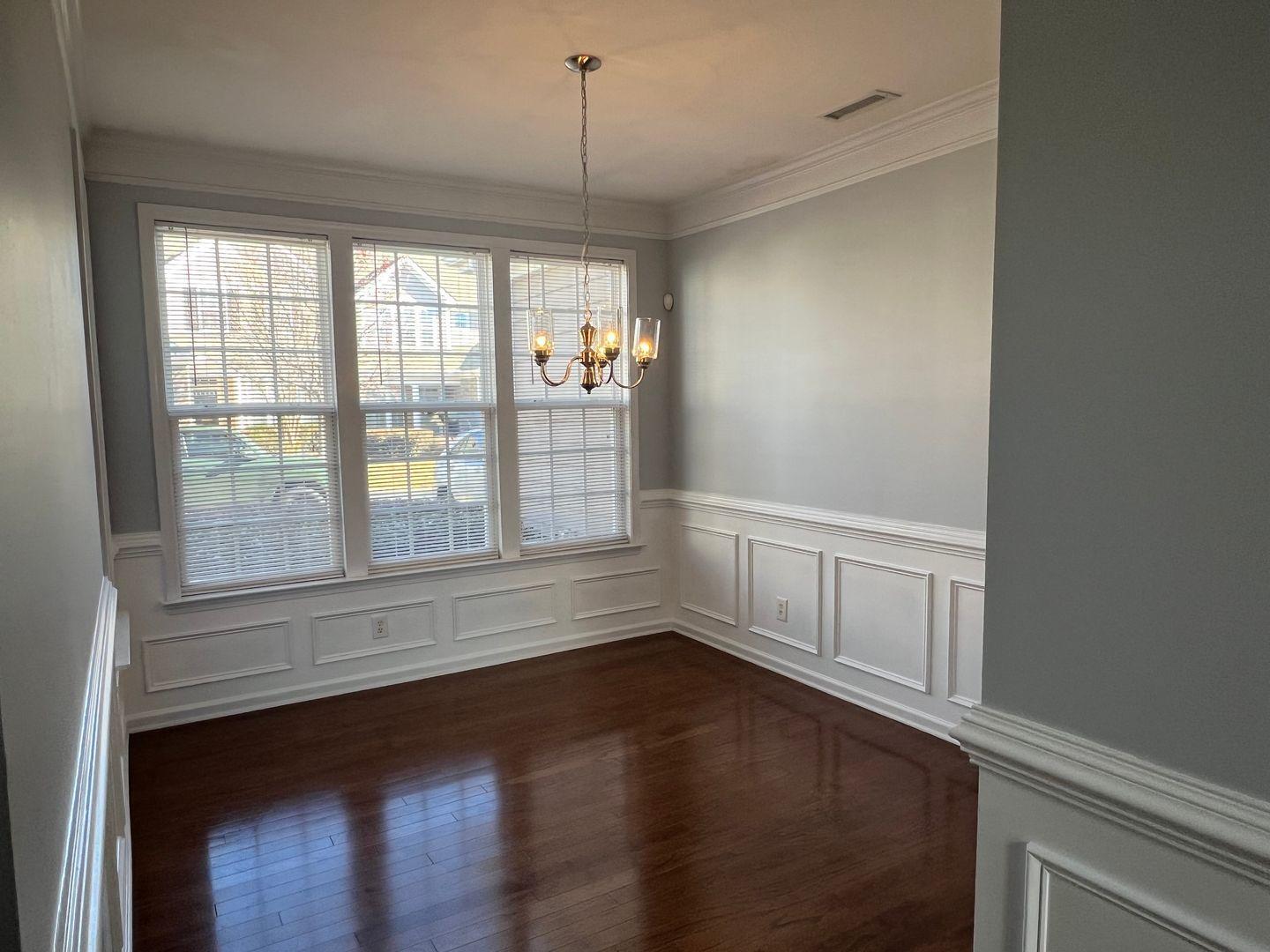 10117 Falls Meadow Court Raleigh, NC 27617 - Photo 22 of 34 a view of an empty room with wooden floor and a window