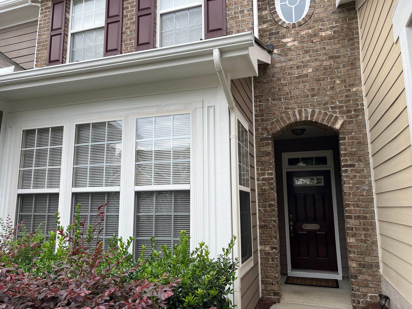 10117 Falls Meadow Court Raleigh, NC 27617 - Photo 3 of 34 front view of a brick house with a large window