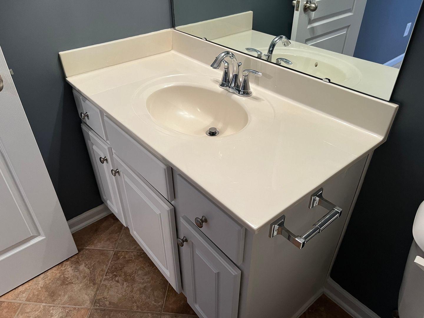 10117 Falls Meadow Court Raleigh, NC 27617 - Photo 31 of 34 a bathroom with a sink and a mirror