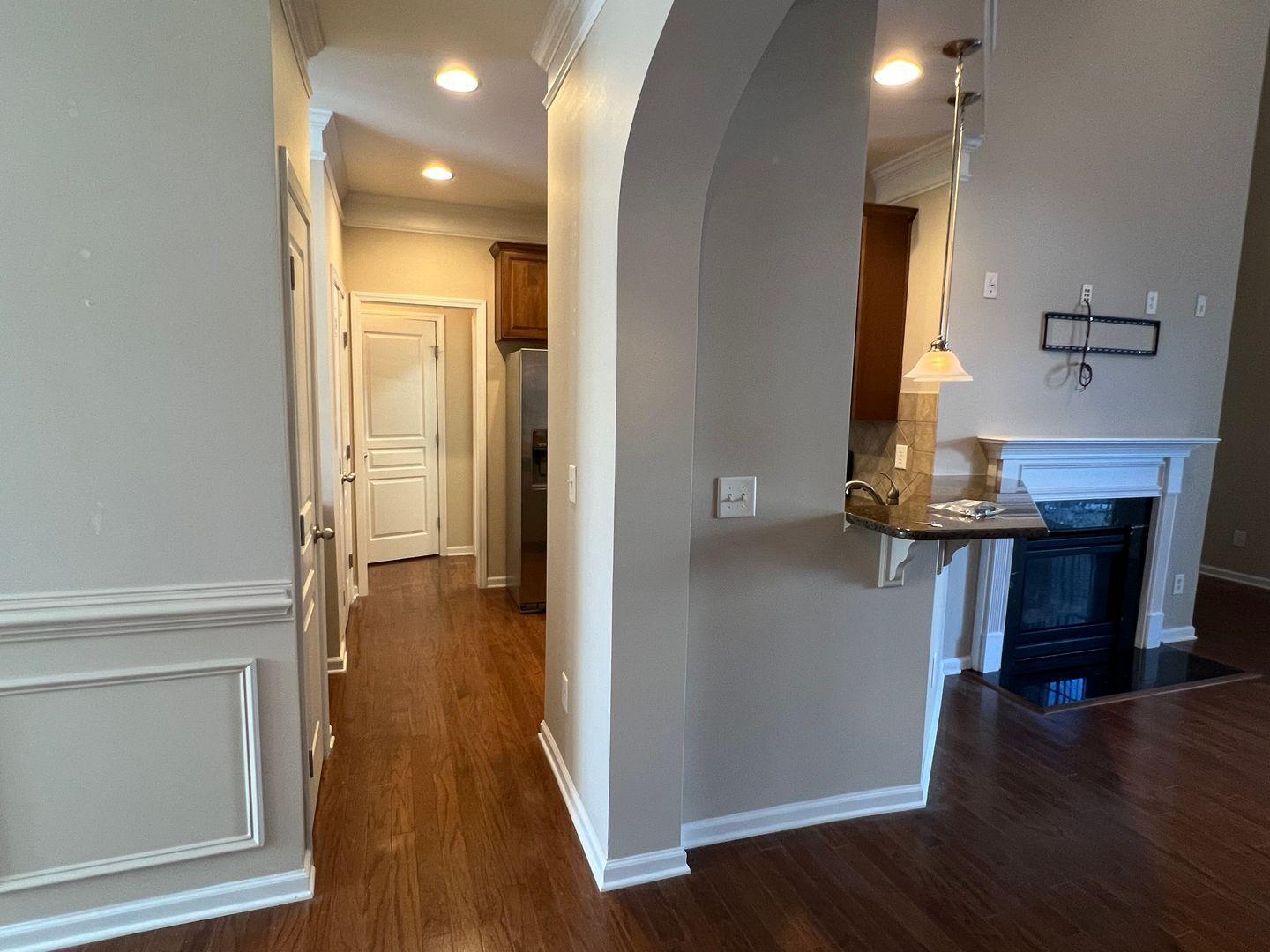 10117 Falls Meadow Court Raleigh, NC 27617 - Photo 8 of 34 a view of a hallway with wooden floor and staircase