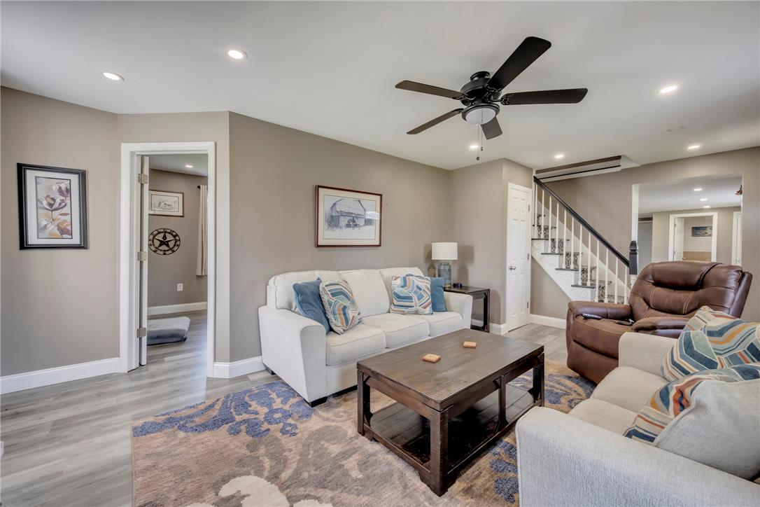439 Cherry Hill Road Nazareth, PA 18064 - Photo 10 of 31 Recessed lighting illuminates a comfortable living room with elegant hardwood flooring and a stylish ceiling fan.