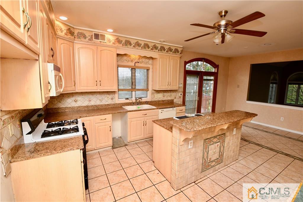 267 Summer Road Neshanic Station, NJ 08853 - Photo 11 of 25 a kitchen with a stove a sink and a refrigerator