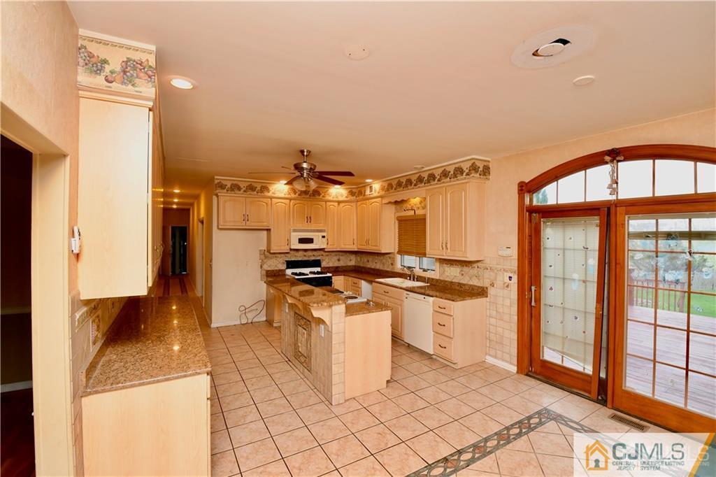 267 Summer Road Neshanic Station, NJ 08853 - Photo 9 of 25 a kitchen with stainless steel appliances granite countertop a stove a sink and a refrigerator