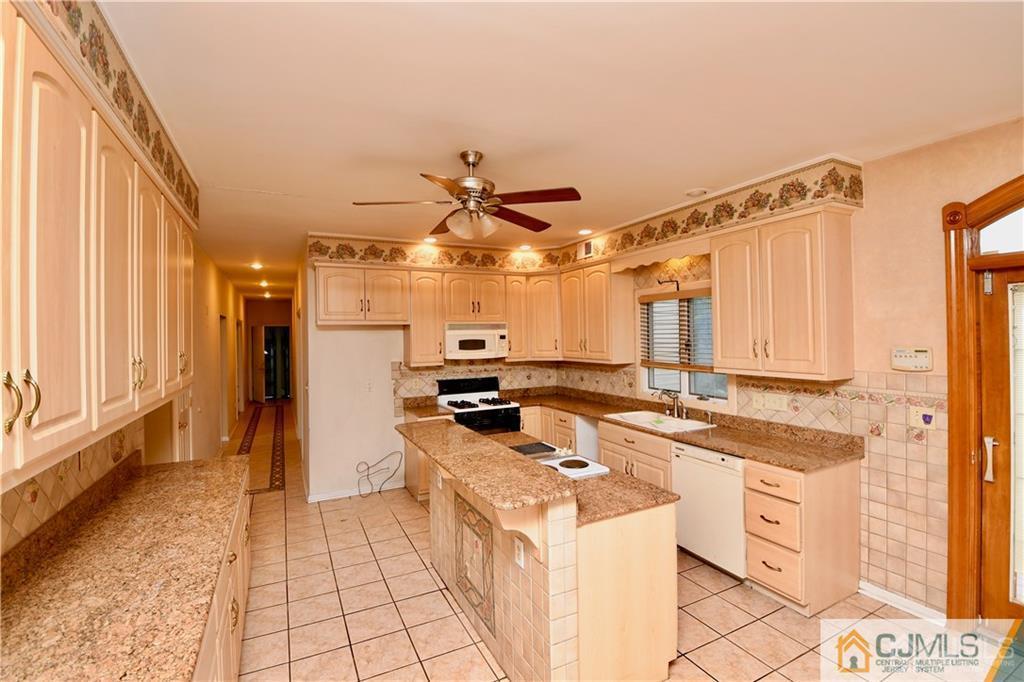 267 Summer Road Neshanic Station, NJ 08853 - Photo 10 of 25 a kitchen with stainless steel appliances granite countertop a sink and cabinets