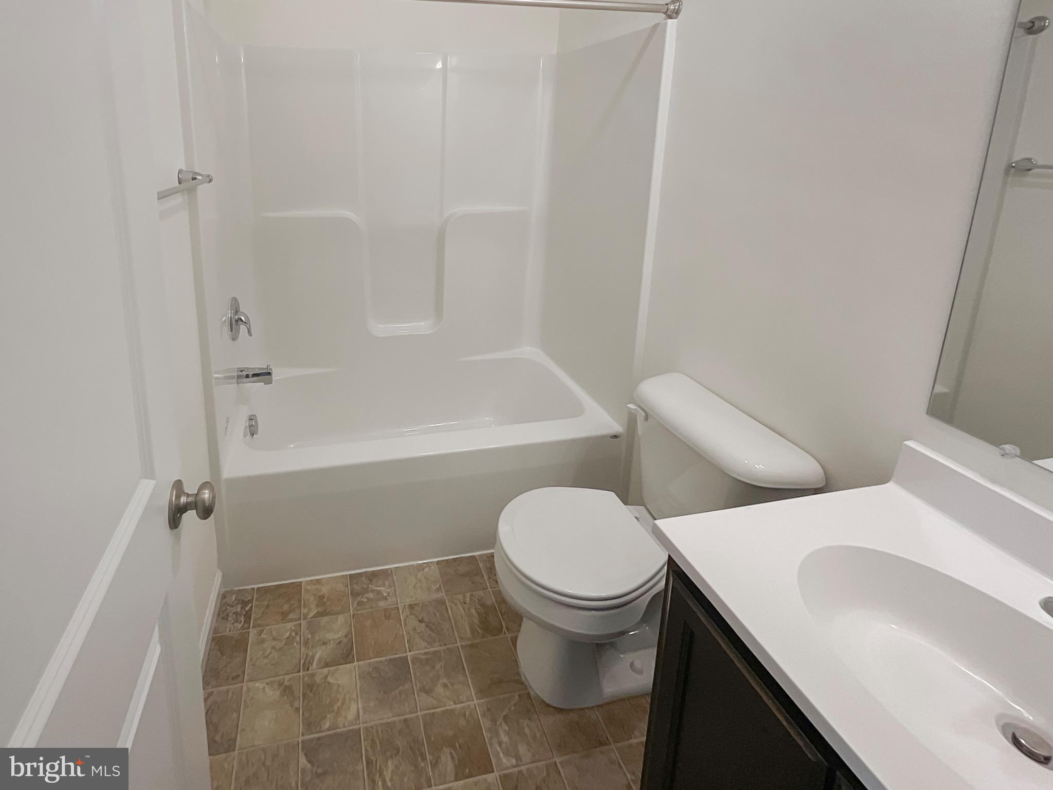 109 Holstein Drive Hanover, PA 17331 - Photo 11 of 26 a white toilet sitting next to a bath tub