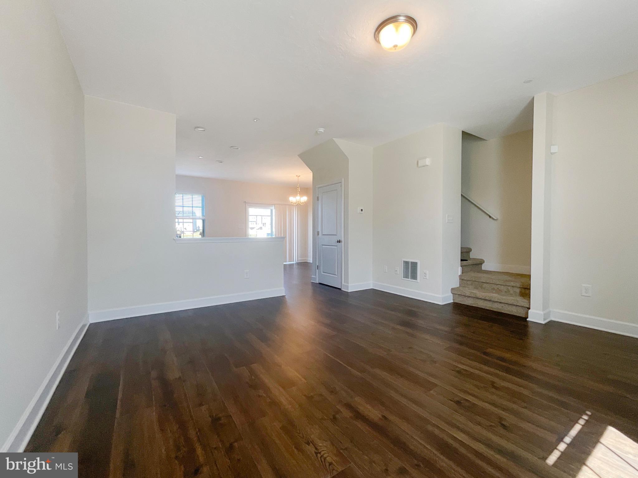 109 Holstein Drive Hanover, PA 17331 - Photo 5 of 26 an empty room with wooden floor and windows