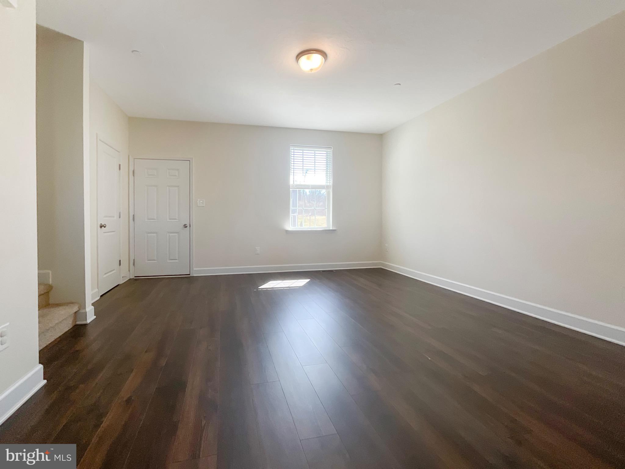 109 Holstein Drive Hanover, PA 17331 - Photo 6 of 26 an empty room with wooden floor and windows
