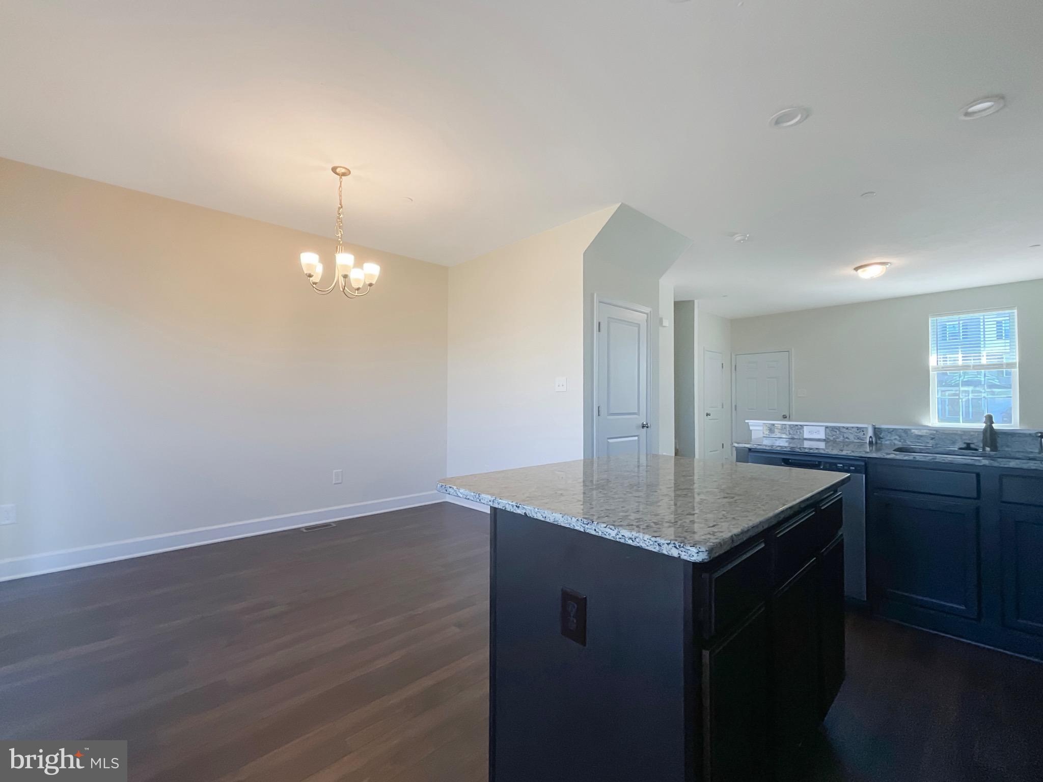 109 Holstein Drive Hanover, PA 17331 - Photo 8 of 26 a kitchen with granite countertop a sink cabinets and wooden floor