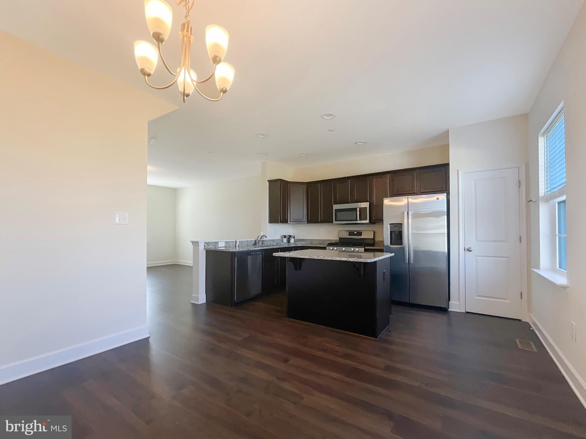 109 Holstein Drive Hanover, PA 17331 - Photo 9 of 26 a large kitchen with a wooden floor and stainless steel appliances