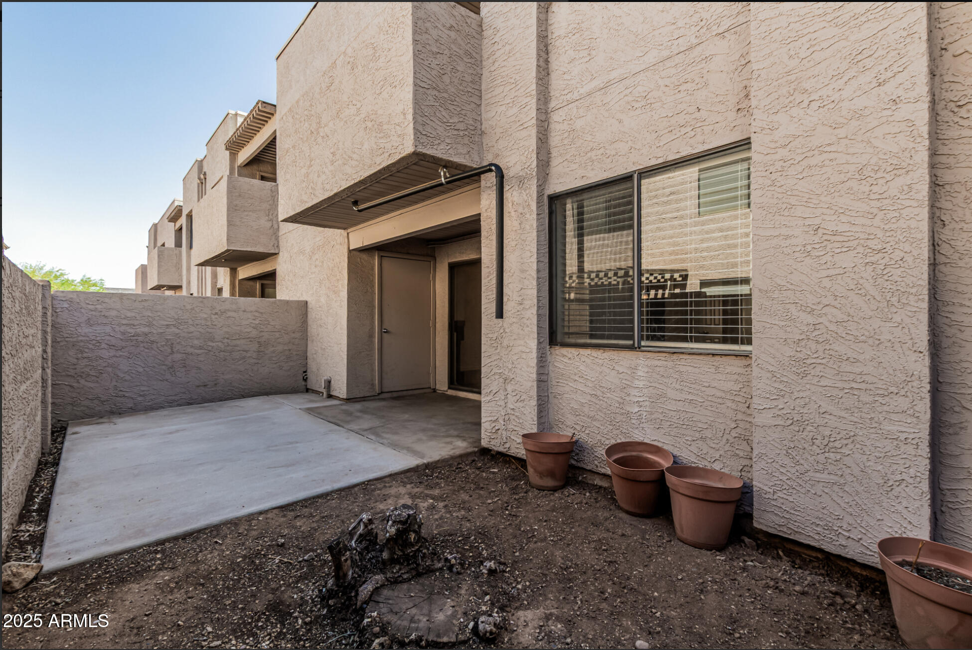 1065 West 1st Street, Unit 102 Tempe, AZ 85281 - Photo 21 of 24 a view of a patio with chair and tables