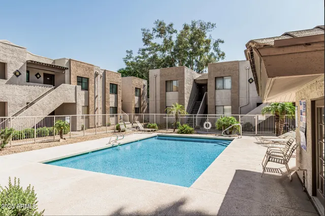 a view of a house with couches and swimming pool