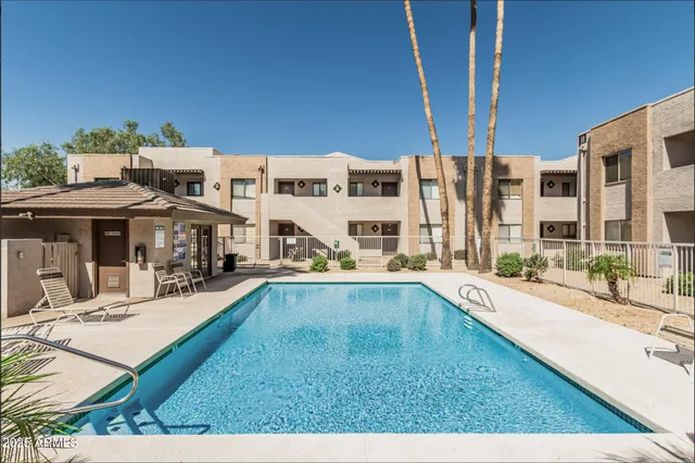 a view of a house with swimming pool and sitting area