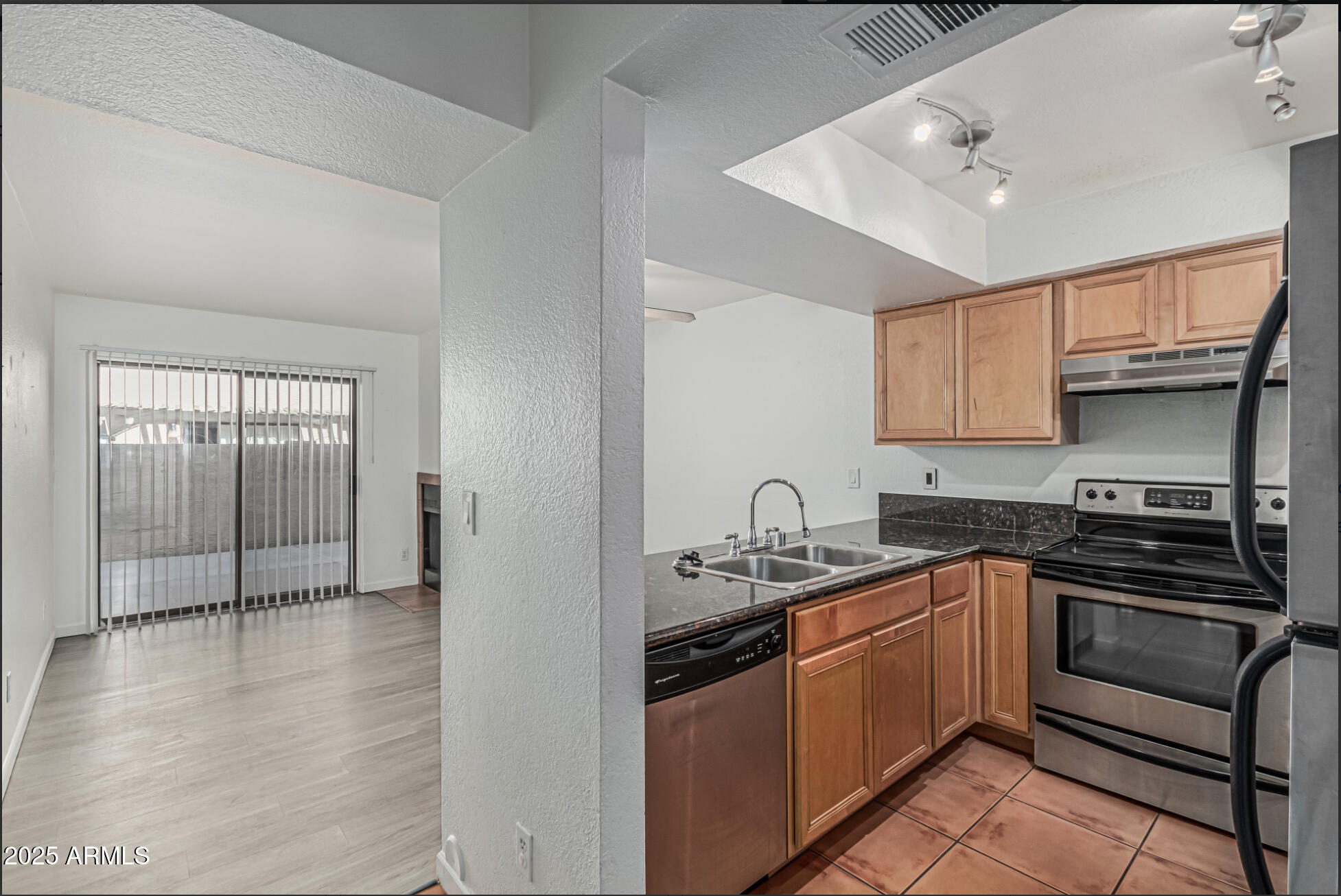 1065 West 1st Street, Unit 102 Tempe, AZ 85281 - Photo 3 of 24 a kitchen with stainless steel appliances granite countertop a sink stove and cabinets