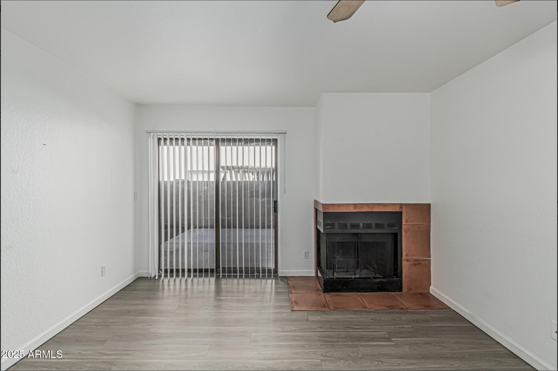 1065 West 1st Street, Unit 102 Tempe, AZ 85281 - Photo 4 of 24 an empty room with wooden floor cabinet and windows
