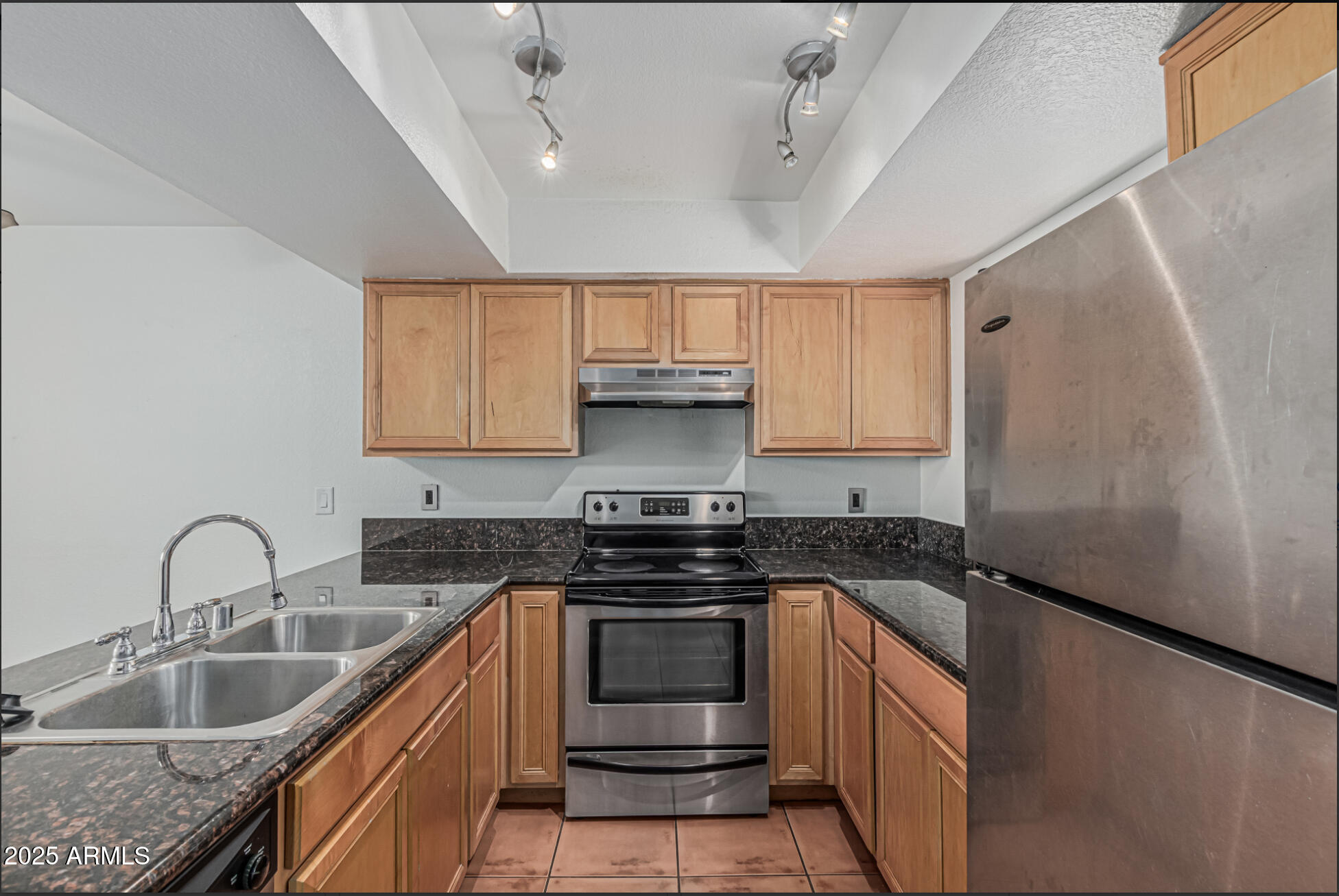 1065 West 1st Street, Unit 102 Tempe, AZ 85281 - Photo 7 of 24 a kitchen with granite countertop a sink stove and refrigerator