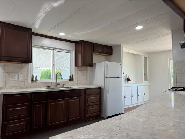 a kitchen with refrigerator cabinets and a sink