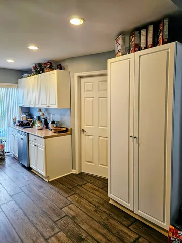a kitchen with refrigerator and cabinets