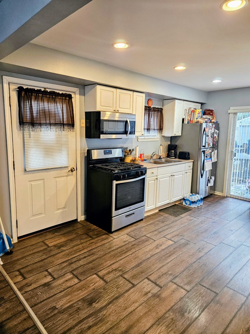 1213 West Main Street Ottawa, IL 61350 - Photo 6 of 11 a kitchen with stainless steel appliances granite countertop a refrigerator and a stove top oven
