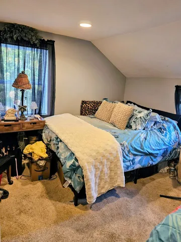a bedroom with a bed and a lamp