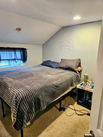 a bedroom with a bed and a dresser in it