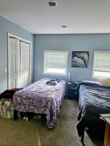 a bedroom with bed and window