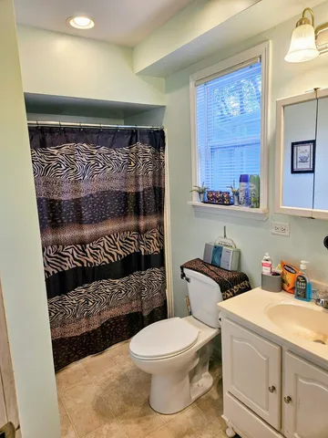 a bathroom with a toilet a sink and a shower