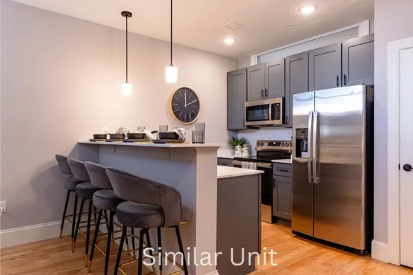 a kitchen with a refrigerator a sink and appliances