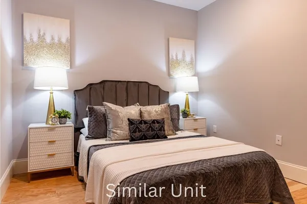 a bedroom with a bed and a night stand