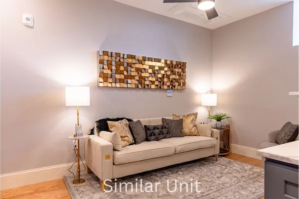 a kitchen with stainless steel appliances granite countertop a refrigerator a stove and a sink with wooden floor