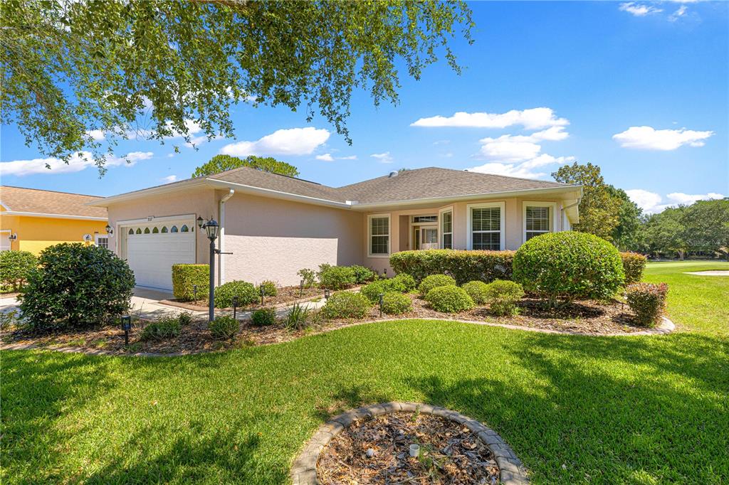 9317 Southwest 94th Loop Ocala, FL 34481 - Photo 39 of 40 a front view of a house with a yard