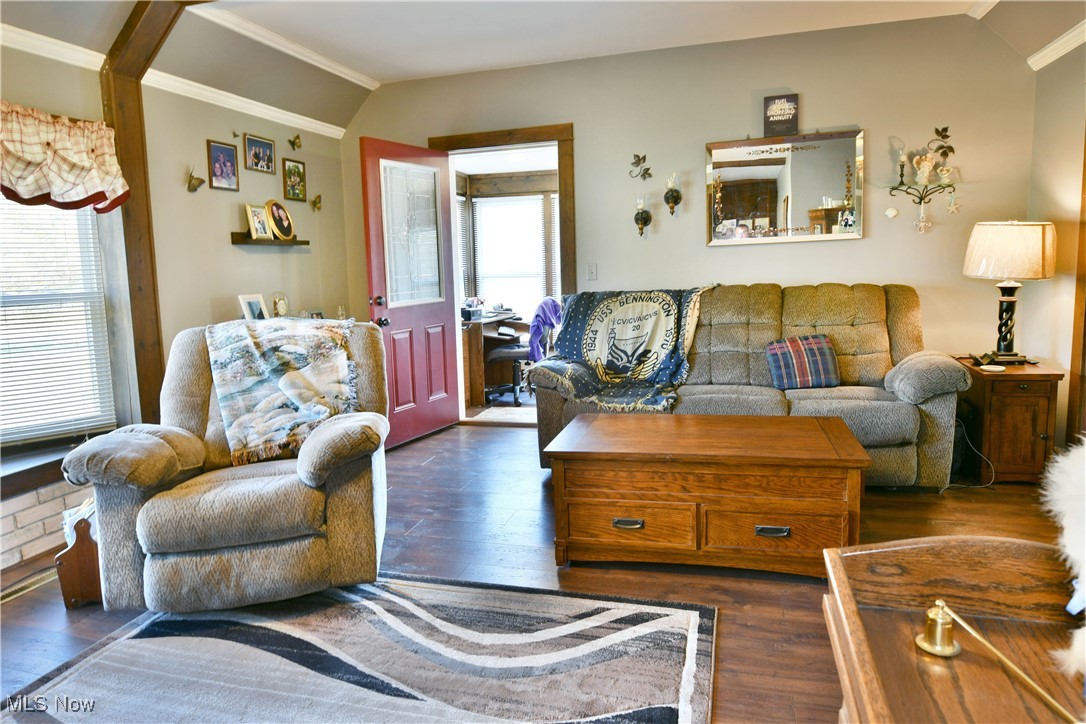 1509 State Road Northwest Warren, OH 44481 - Photo 18 of 49 Living room with dark wood-type flooring, vaulted ceiling, and crown molding