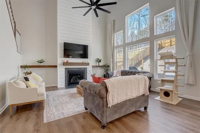 a living room with furniture wooden floor and a large window
