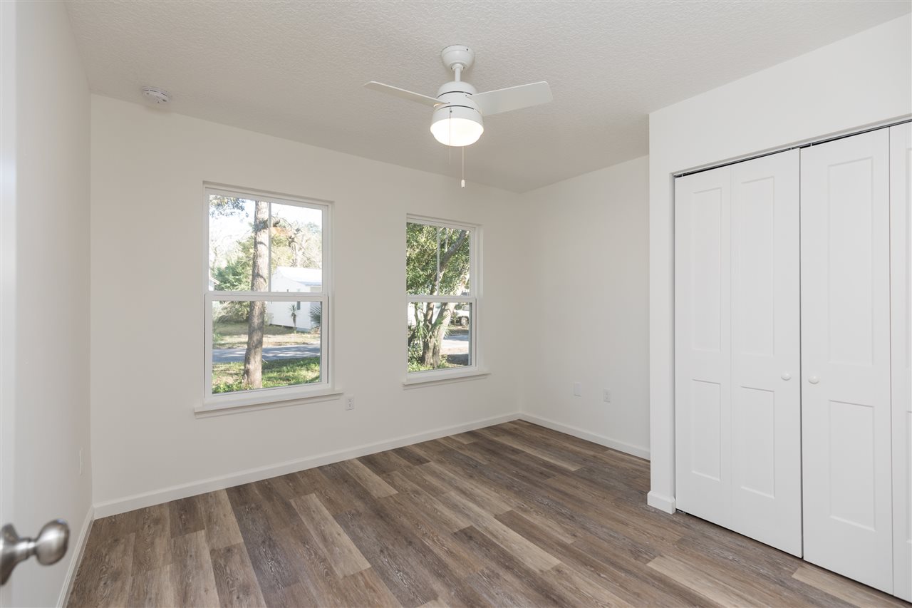 68 Spring Street St. Augustine, FL 32084 - Photo 10 of 22 a view of an empty room with wooden floor and a window