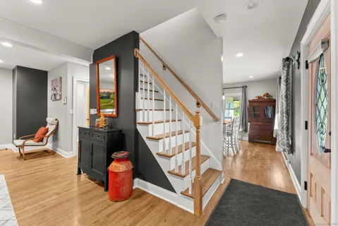 wooden floor view with staircase and living room