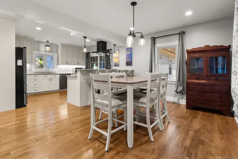 a view of a dining room with furniture window and wooden floor