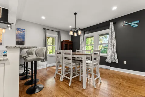 a view of a dining room with furniture window and wooden floor