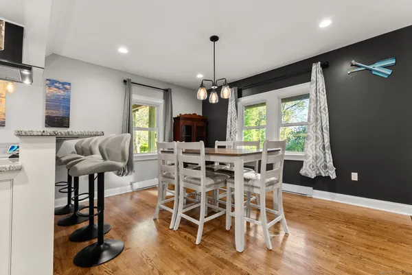 a view of a dining room with furniture window and wooden floor